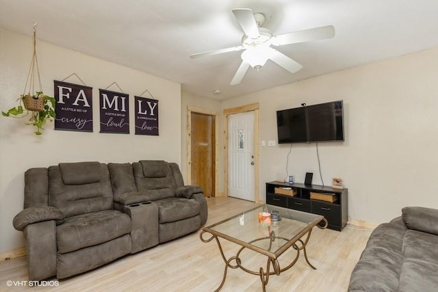 living room with ceiling fan and hardwood / wood-style flooring