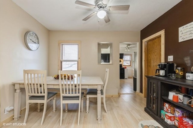 dining space featuring light wood-type flooring, ceiling fan, and plenty of natural light