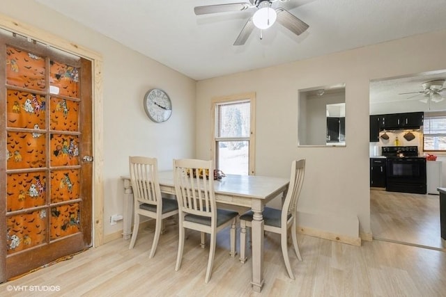 dining room with light wood-type flooring and ceiling fan