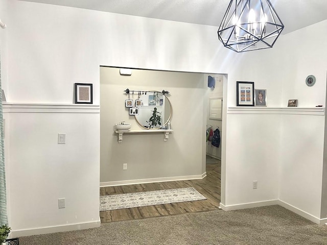 interior space featuring hardwood / wood-style floors and an inviting chandelier