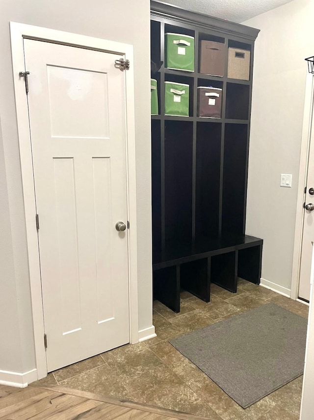 mudroom with a textured ceiling and hardwood / wood-style flooring