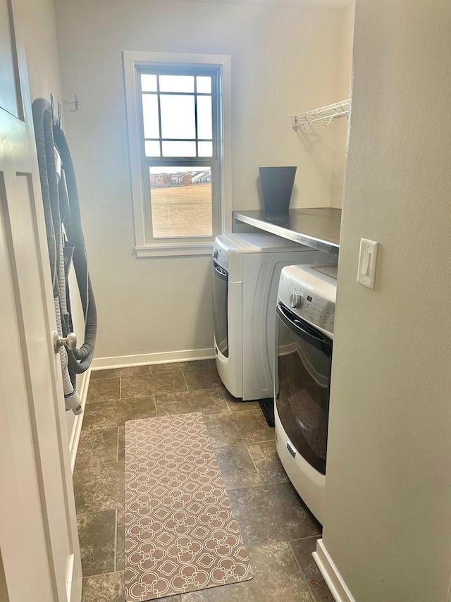 clothes washing area with washing machine and dryer