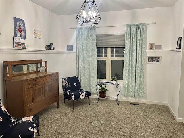 sitting room with carpet flooring and a notable chandelier