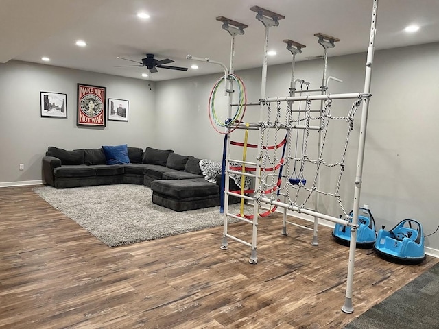 living room with hardwood / wood-style floors and ceiling fan