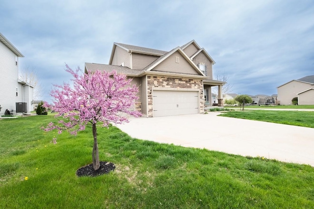 craftsman-style home with a front lawn, central air condition unit, stone siding, and concrete driveway