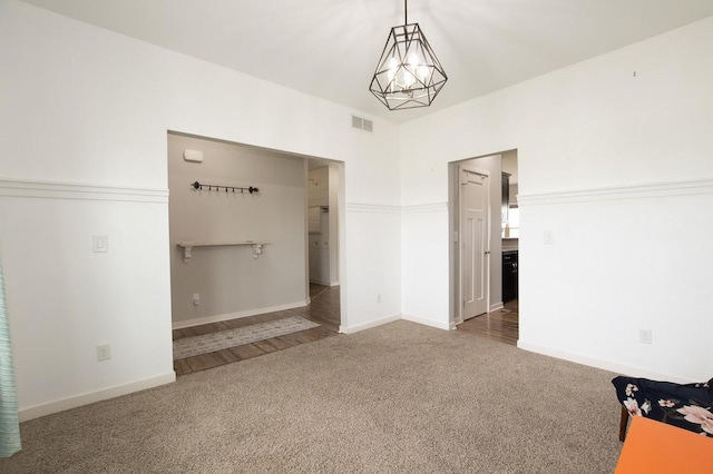 interior space featuring visible vents, carpet flooring, and baseboards
