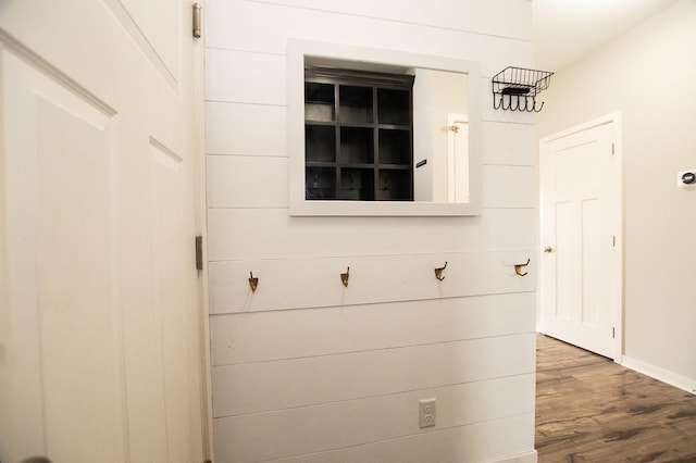 interior space featuring baseboards and wood finished floors