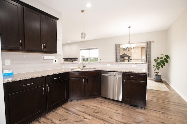 kitchen featuring a sink, light wood-style floors, a peninsula, and dishwasher