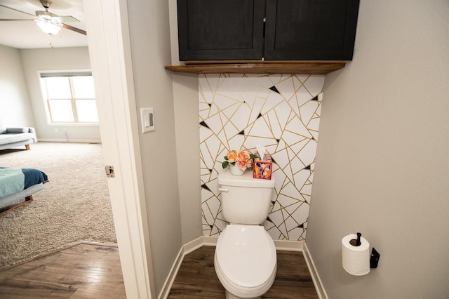 bathroom featuring toilet, baseboards, a ceiling fan, and wood finished floors