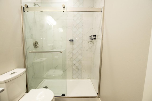 full bath featuring toilet and a stall shower