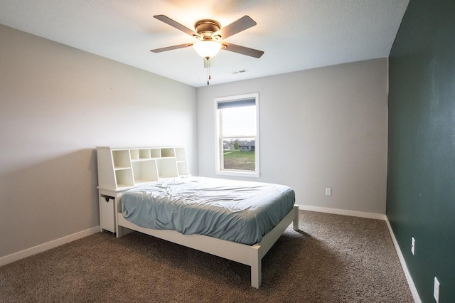 bedroom with dark carpet, baseboards, and ceiling fan