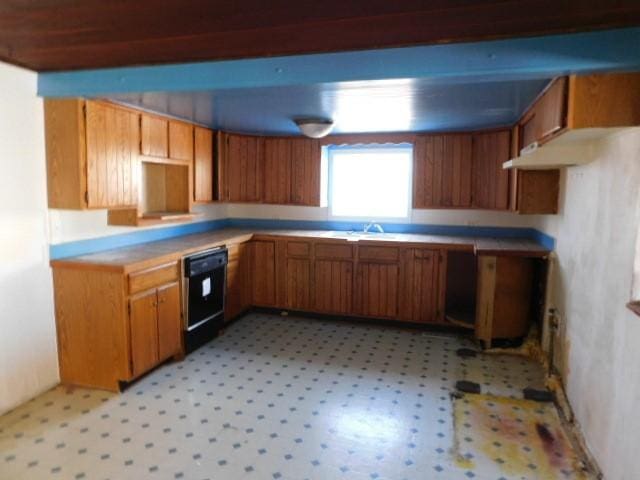 1316 Locust St, West Des Moines, IA 50265 - kitchen featuring light floors, a sink, brown cabinets, and black dishwasher