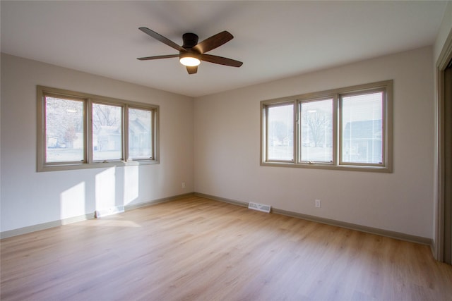 empty room featuring ceiling fan and light wood-type flooring