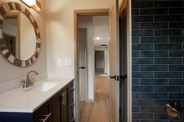 bathroom with hardwood / wood-style floors and vanity