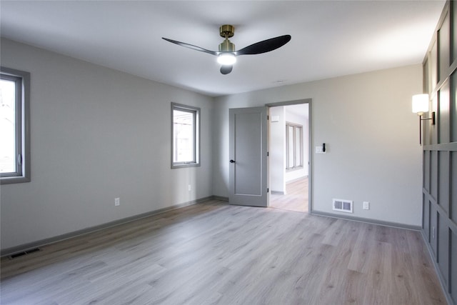 unfurnished room featuring ceiling fan and light hardwood / wood-style floors