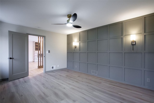 unfurnished bedroom with ceiling fan and light wood-type flooring