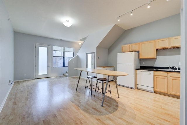 kitchen with light hardwood / wood-style floors, white appliances, sink, and light brown cabinets