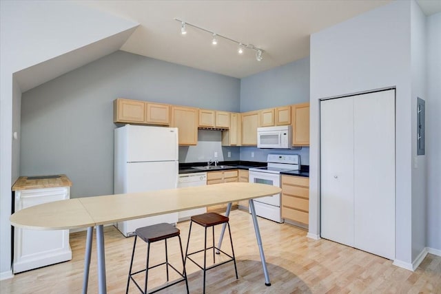 kitchen featuring light hardwood / wood-style floors, sink, white appliances, high vaulted ceiling, and light brown cabinetry