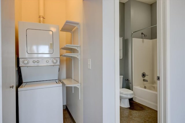 clothes washing area with stacked washer / dryer