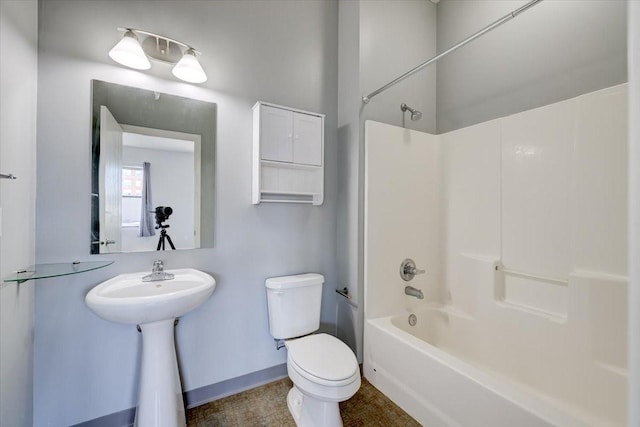 bathroom with shower / bathtub combination and toilet