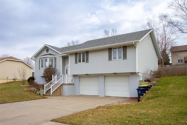 raised ranch with a front lawn and a garage