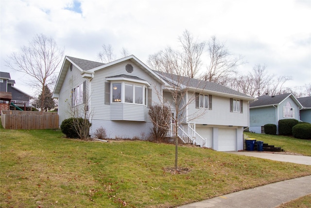 view of front of home with a front yard and a garage