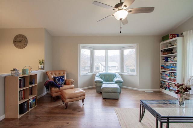 living area featuring hardwood / wood-style flooring and ceiling fan