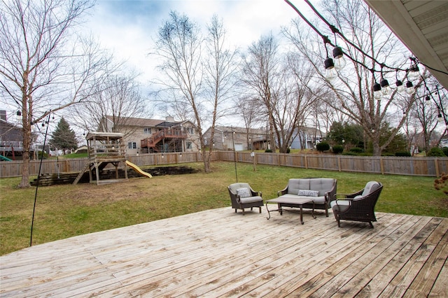 wooden deck with an outdoor living space, a playground, and a lawn