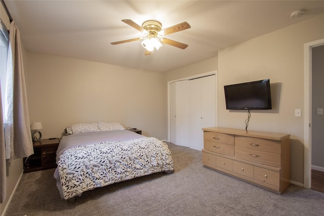 carpeted bedroom with a closet and ceiling fan