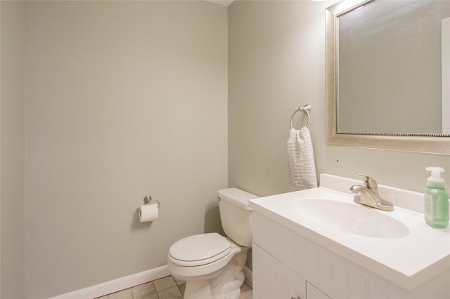 bathroom featuring tile patterned floors, vanity, and toilet