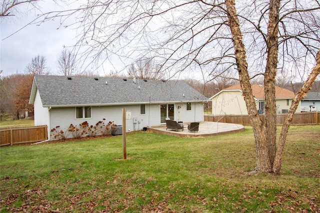 rear view of property featuring a lawn and a patio