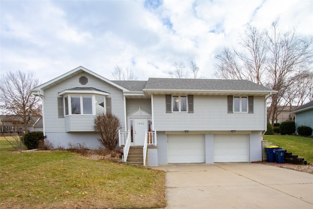 split foyer home with a garage and a front lawn