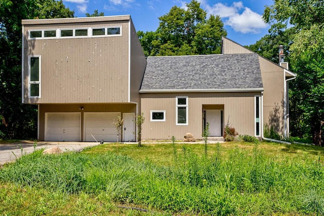 modern home featuring a garage and a front yard