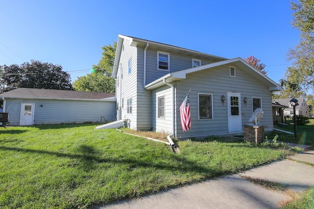 back of property featuring a yard