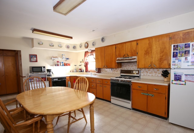 kitchen featuring decorative backsplash and white appliances