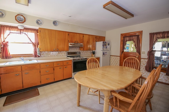 kitchen featuring white appliances and sink