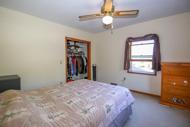 carpeted bedroom featuring ceiling fan and a closet