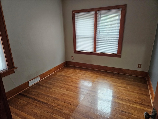 empty room with hardwood / wood-style flooring