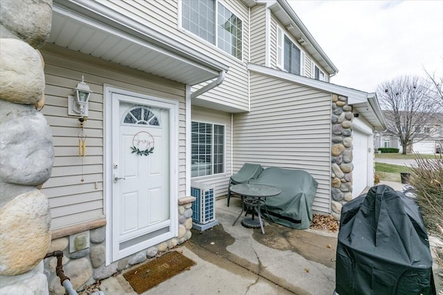 entrance to property featuring cooling unit