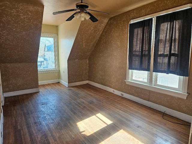 bonus room with wood-type flooring, vaulted ceiling, plenty of natural light, and ceiling fan