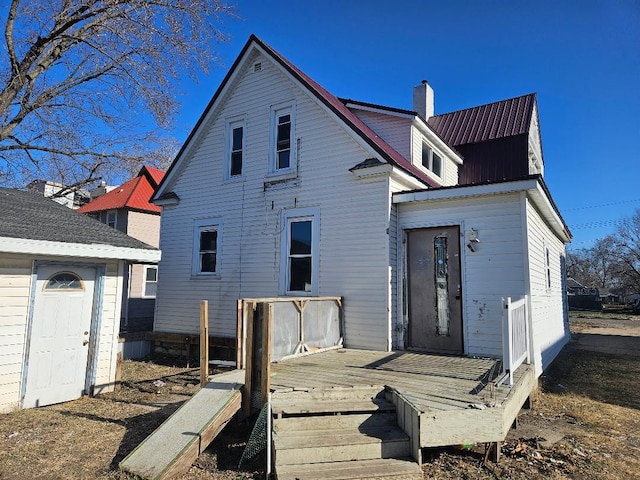 back of house with a deck