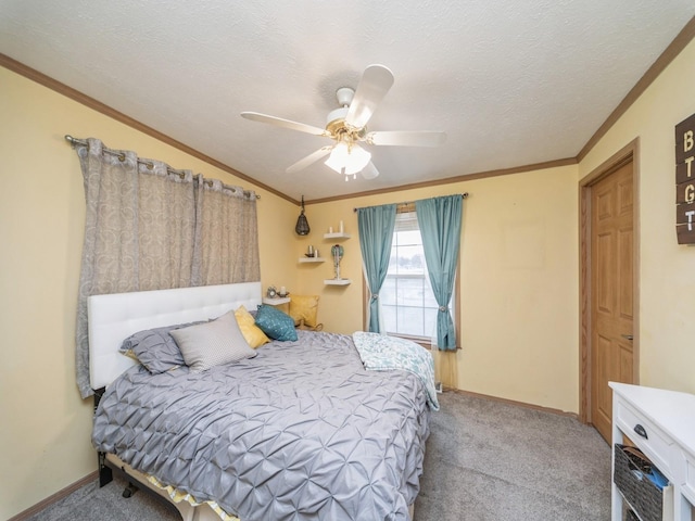 bedroom with ceiling fan, crown molding, light colored carpet, and a textured ceiling