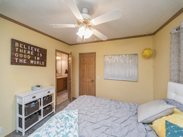 carpeted bedroom featuring ceiling fan, ensuite bathroom, a textured ceiling, and ornamental molding