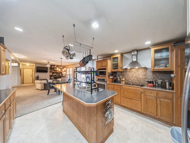 kitchen with a center island, a kitchen breakfast bar, wall chimney range hood, tasteful backsplash, and stainless steel appliances