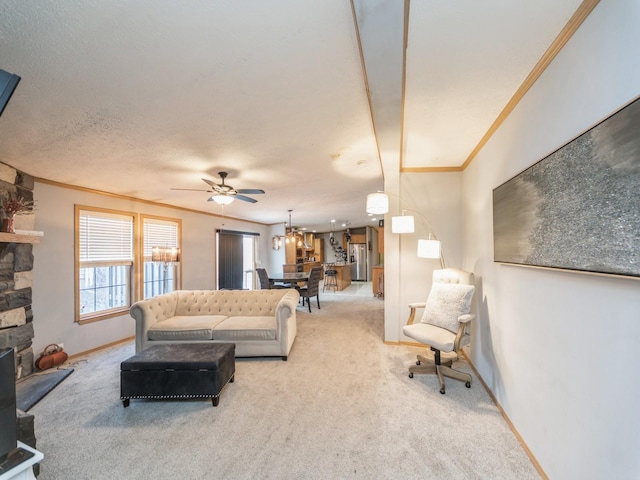 carpeted living room featuring a stone fireplace, ceiling fan, a textured ceiling, and ornamental molding