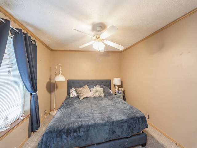 carpeted bedroom featuring ceiling fan, ornamental molding, and a textured ceiling