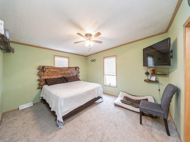 bedroom featuring carpet, a textured ceiling, and ceiling fan