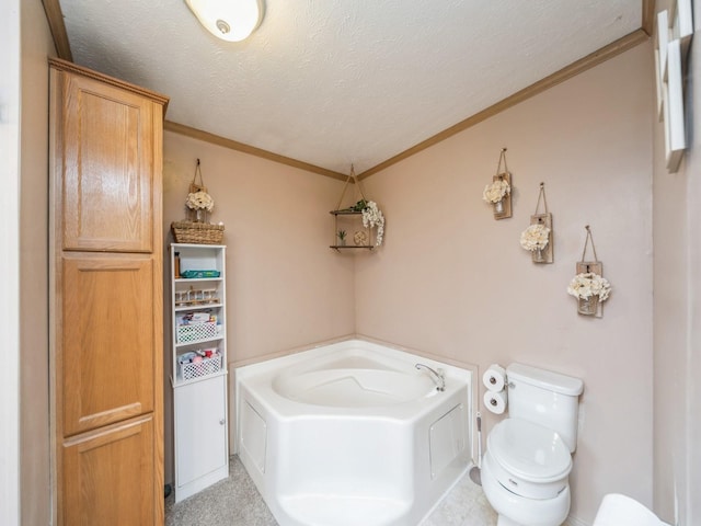 bathroom featuring ornamental molding, a textured ceiling, toilet, and a tub