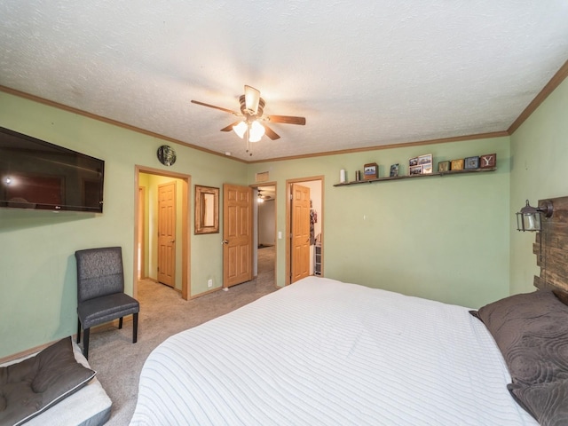 bedroom featuring ceiling fan, ornamental molding, a textured ceiling, and light carpet