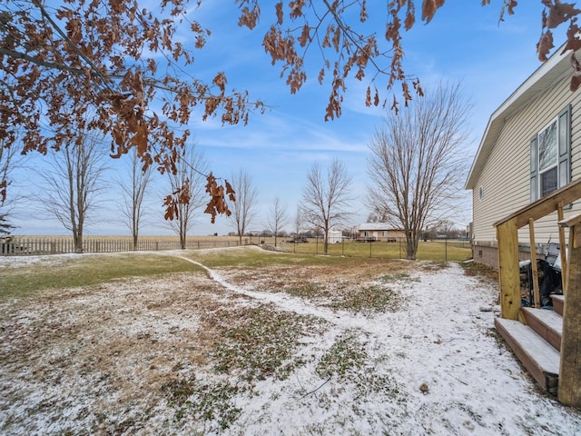 yard layered in snow featuring a rural view